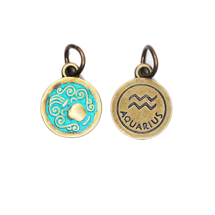 Brass-tone Aquarius zodiac charm painted turquoise. One side depicts an urn overflowing with water. Reverse side shows the water sign and says "AQUARIUS".