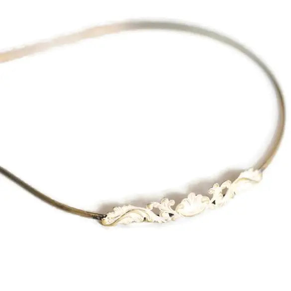 Sweet Nothings Headband with filigree charm, hand-painted by artisans in Denver, flexible fit, hypoallergenic.