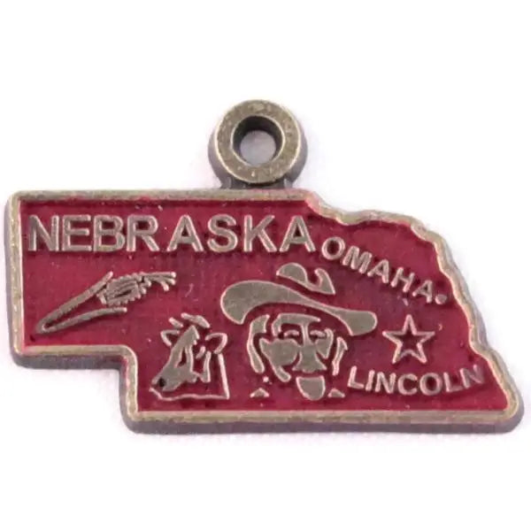 Nebraska map charm representing agricultural heritage, hand-painted, hypoallergenic, available as card, bracelet, or necklace.
