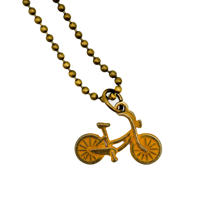 Antique bronze bicycle bike charm hand painted mustard yellow and burnished. Shown on an 18" antique gold ball chain.