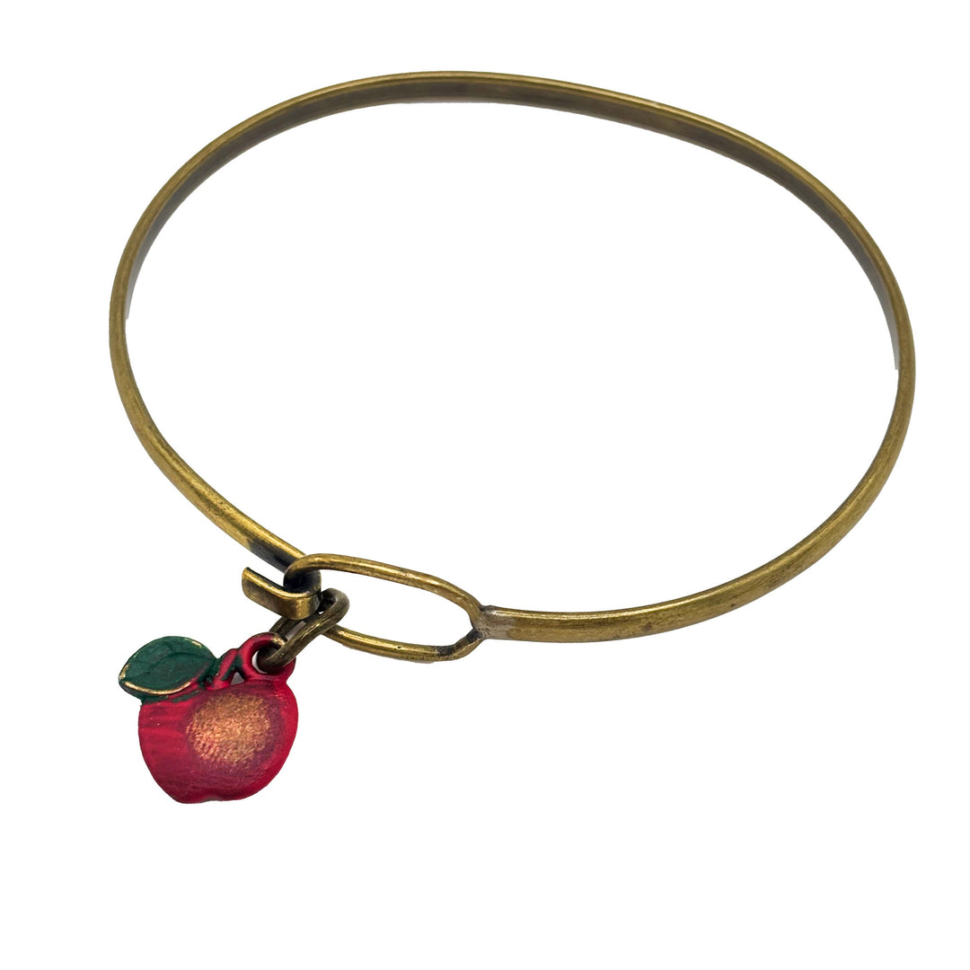 Antique bronze apple charm painted red with a green leaf and burnished to shiny gold. Shown with brass hook bracelet.
