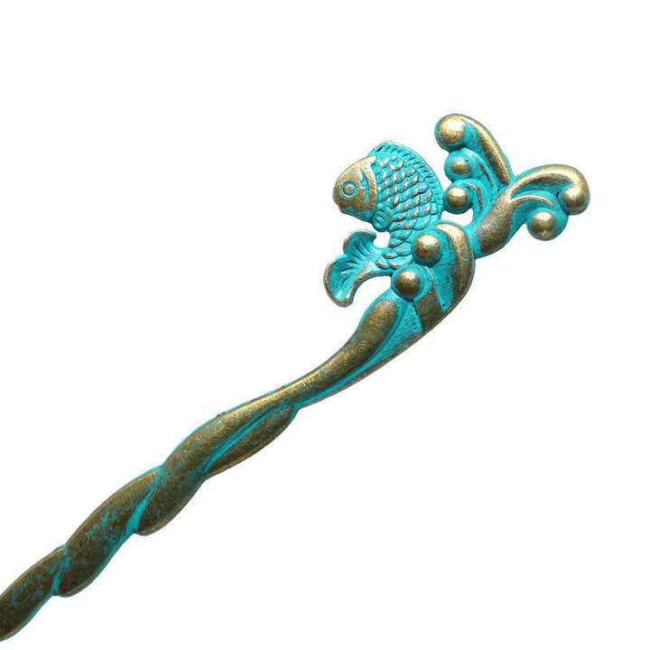 Loose bun styled with Fish Hair Pin, hand-painted by artisans in Denver, CO, 5 1/4” long, hypoallergenic, lead-free, nickel-free.