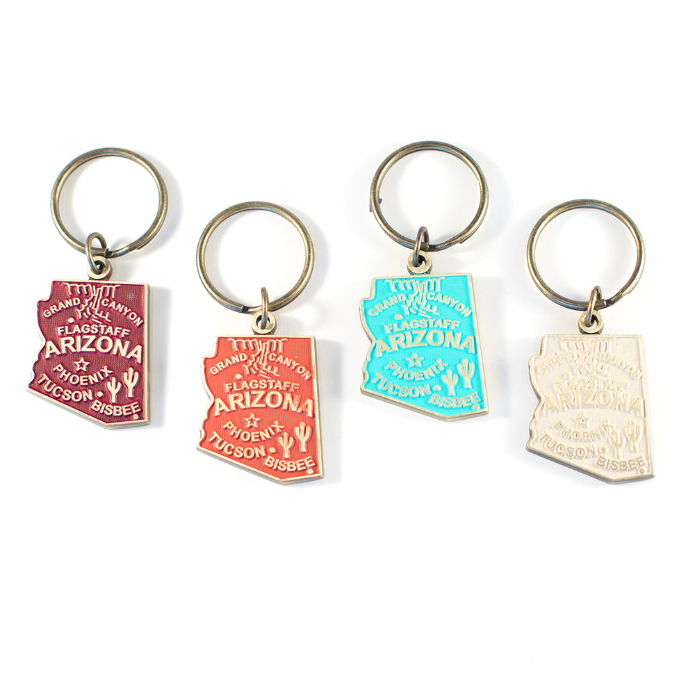 Antique bronze 1 5/8" charm keychain on 1 1/4" keyring. Alaska state charm painted cream and burnished to shiny gold. Map depicts location of Flagstaff, Phoenix, Tucson and Bisbee. Illustrated with the Grand Canyon and Saguaro cacti.