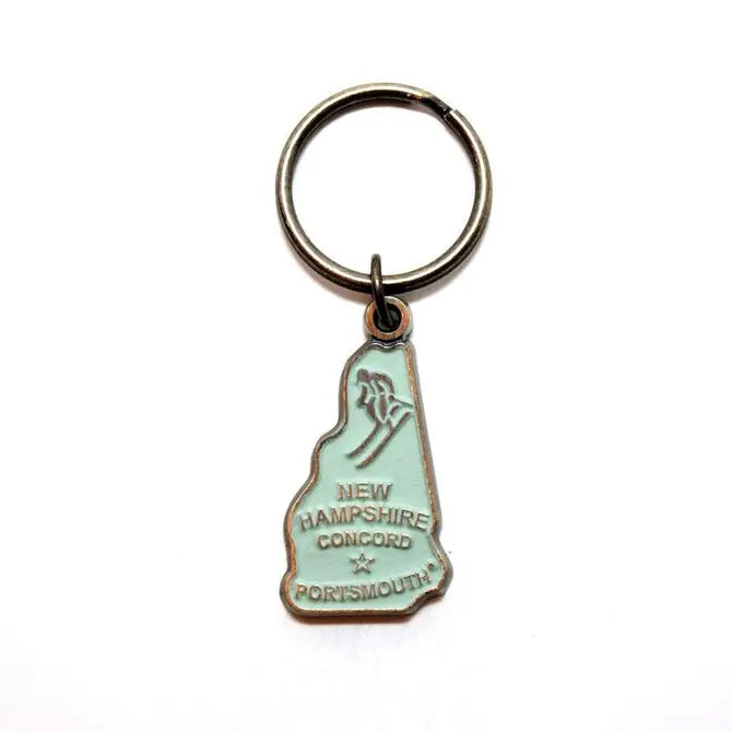 New Hampshire keychain with map and skier charm, 1 3/8” long, hand-painted, hypoallergenic, bronze keychain.