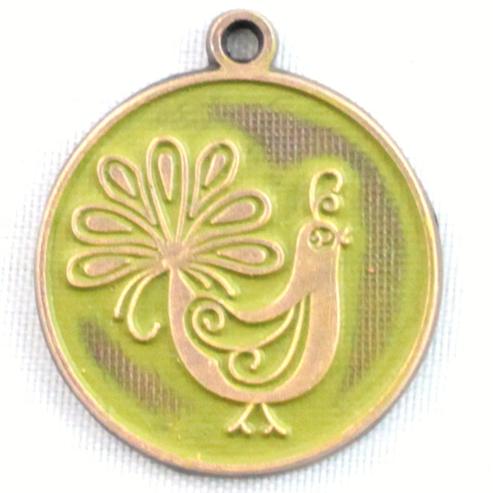Antique bronze charm painted avocado green and burnished to shiny gold. One side depicts a whimsical peacock. Reverse side says "Born to stand out".