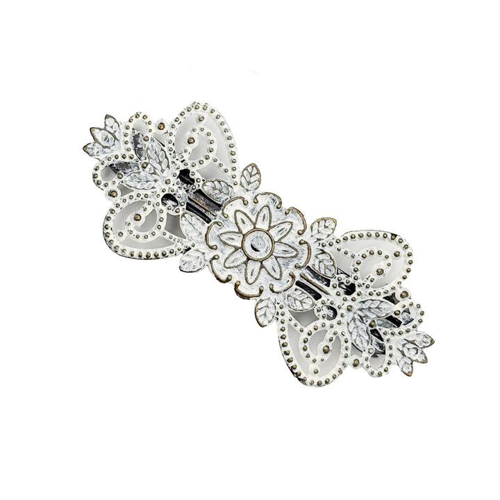 Antique bronze filigree barrette with a flower, vines and leaves. Hand-painted white and burnished to shiny gold.