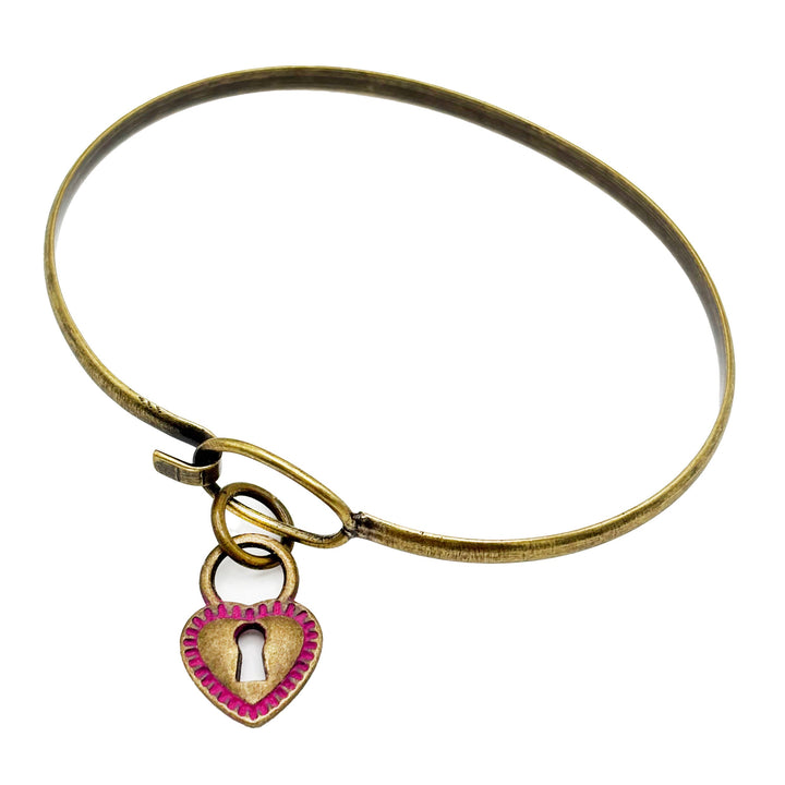 Heart-shaped lock charm, hand-painted, spring colors, available as charm on card, bracelet, or necklace, artisan-made in Denver, 5/8” size, hypoallergenic.