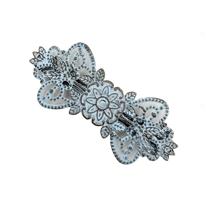 Antique bronze filigree barrette with a flower, vines and leaves. Hand-painted light blue and burnished to shiny gold.