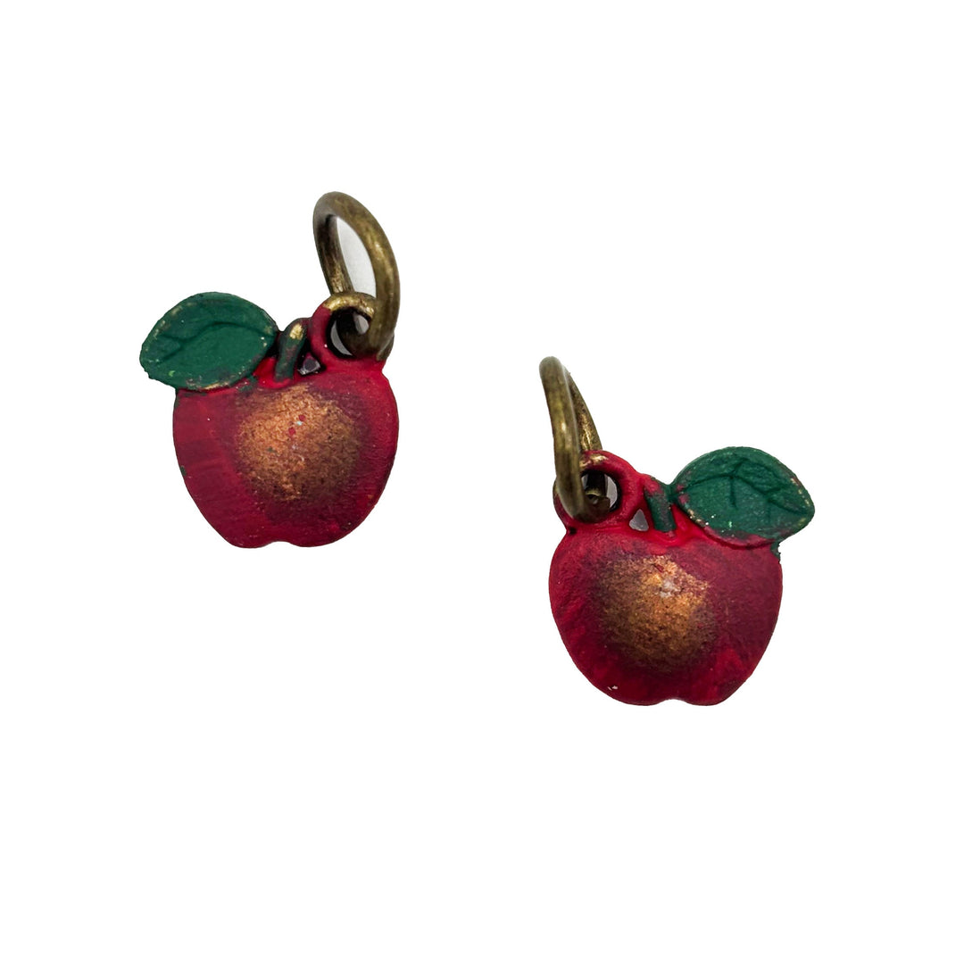 Antique bronze apple charm painted red with a green leaf and burnished to shiny gold. Charms come with attached jump ring.