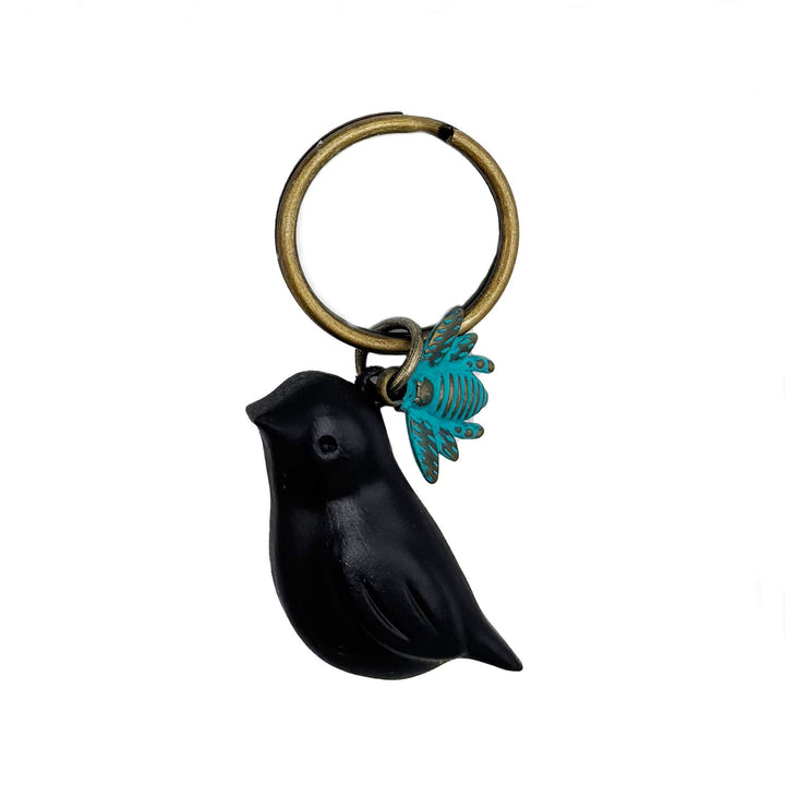 Antique bronze 1 1/2" bird charm with small bee charm keychain on 1 1/4" keyring. Black bird with aqua bee charm.