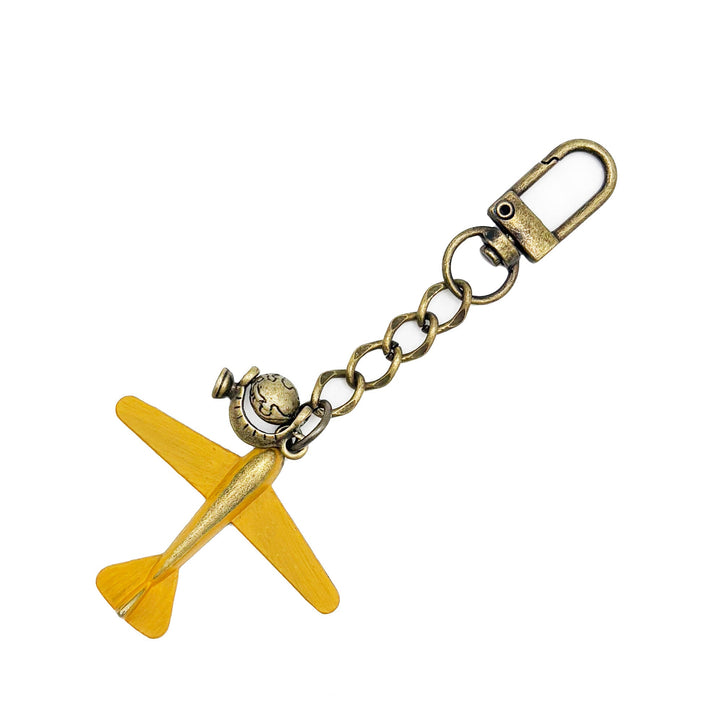 Large antique bronze airplane charm painted yellow with an antique gold rotating globe charm. On a short chain with modern clasp to wear on your purse/handbag. Total length of this bag charm is 4 1/2".