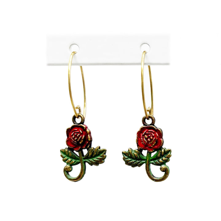 Rose Charm earrings in various colors: Cherry Red for romantic love, White for purity, Vintage Rose for gratitude, Peach for sincerity, Butter for friendship. Hand-painted, hypoallergenic, 5/8" charms on 1" gold-toned dangle wires.