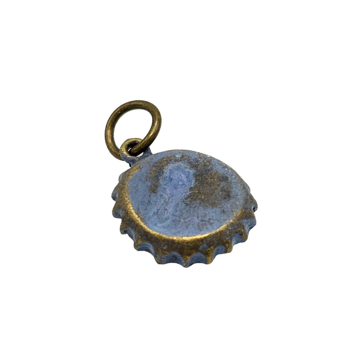 Antique bronze bottle cap charm is painted white and burnished until shiny. Shown on brass hook bracelet. Vintage style.