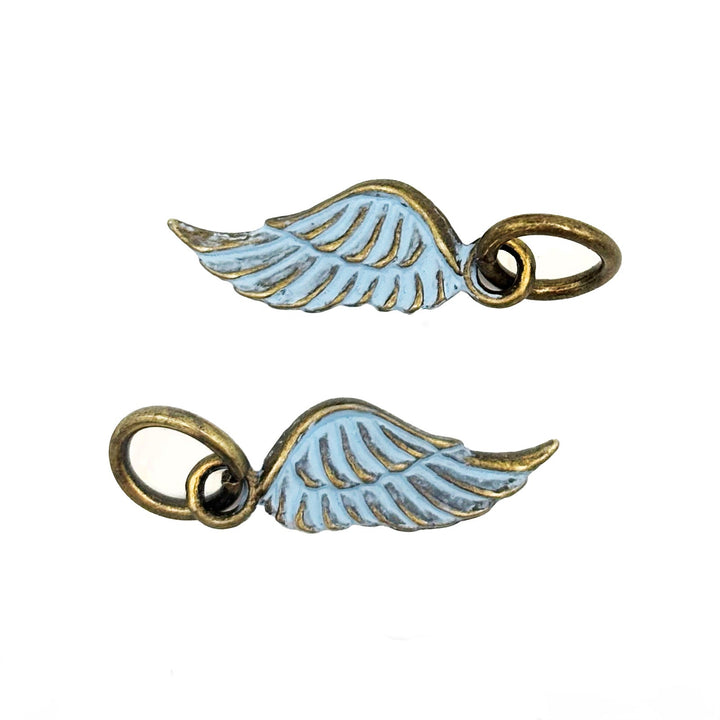 Antique bronze wing charm painted light blue and burnished to shiny gold. Charms come with attached jump ring.