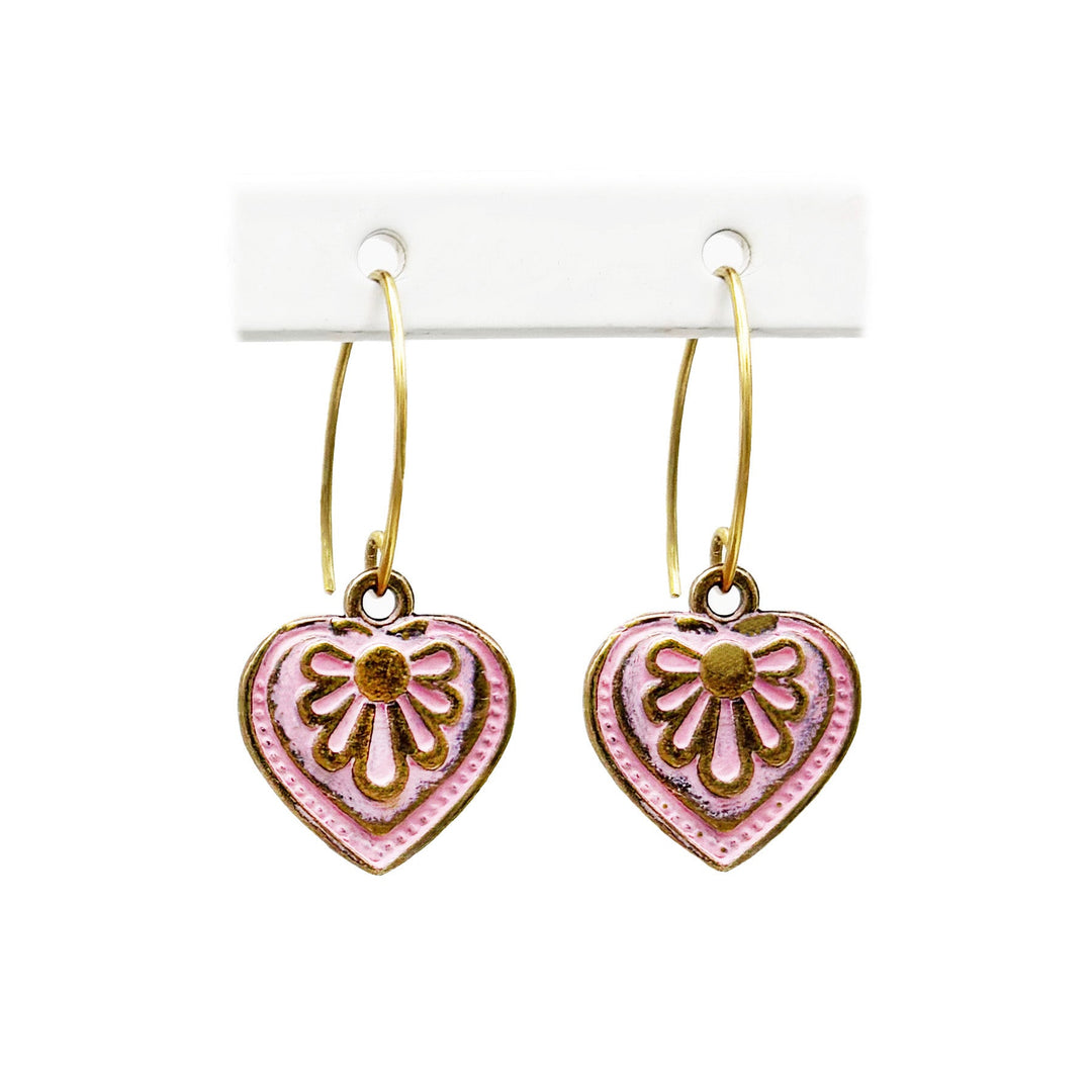 Antique bronze charms painted pink and burnished to shiny gold. on 1" gold ear loops. Graphic details mimic a blooming flower.