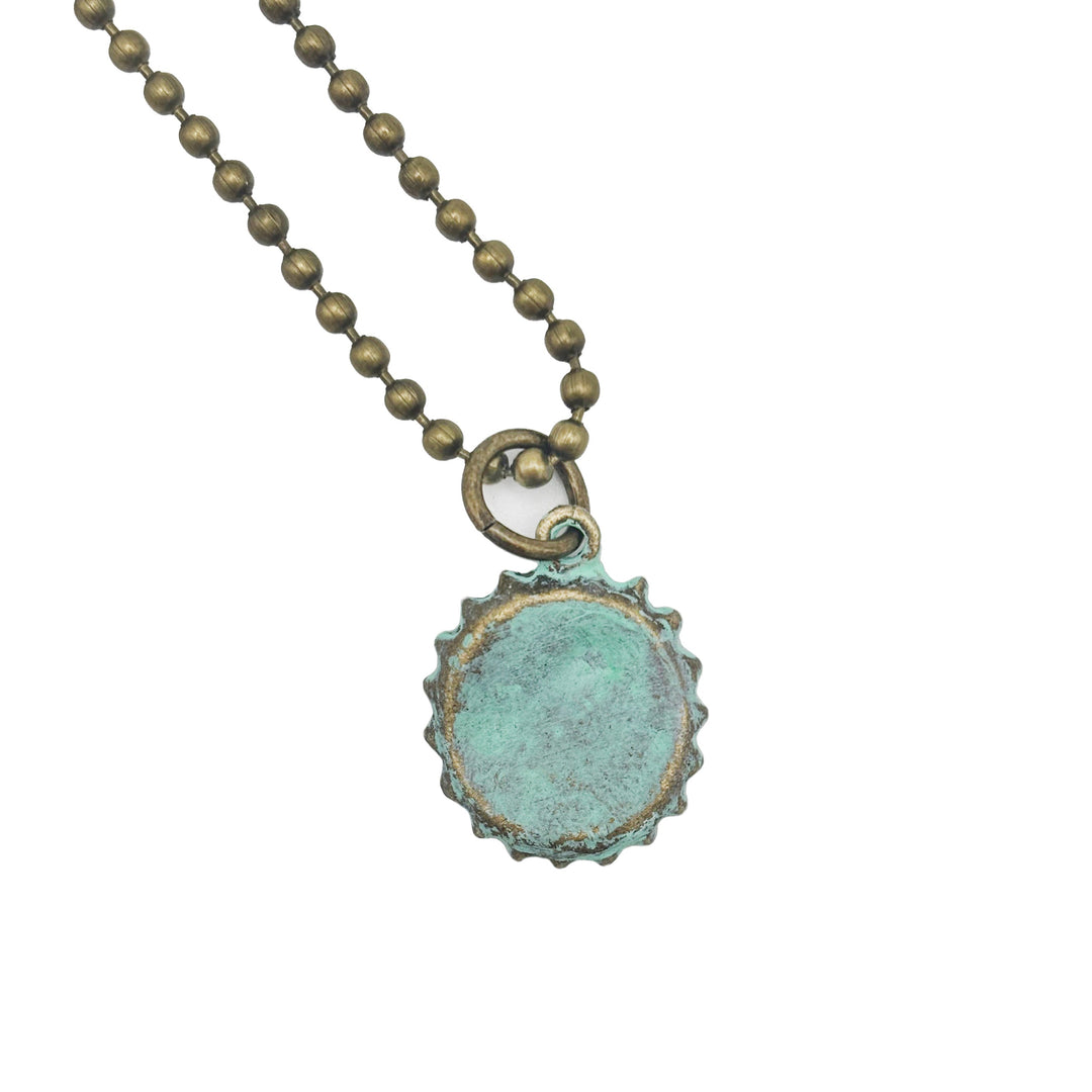 Antique bronze bottle cap charm is painted dark gray and burnished until shiny. Charm comes with jump ring. Vintage style.