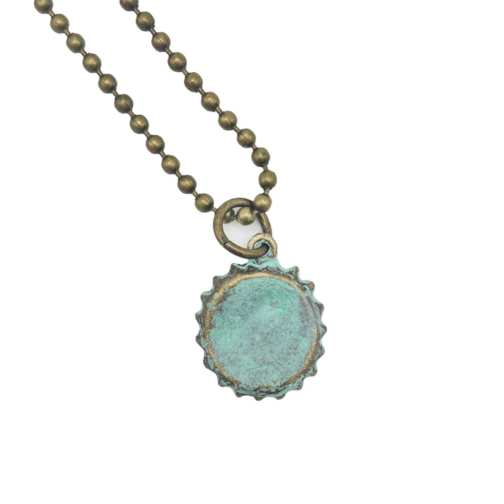 Antique bronze bottle cap charm is painted dark gray and burnished until shiny. Charm comes with jump ring. Vintage style.