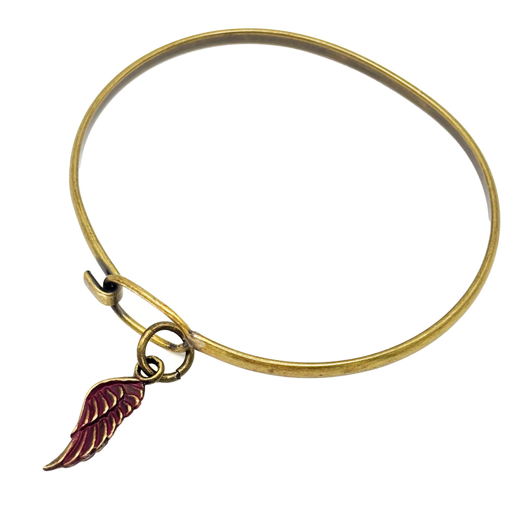 Antique bronze wing charm painted wine red and burnished to shiny gold. Charms come with attached jump ring. Shown on brass hook bracelet.