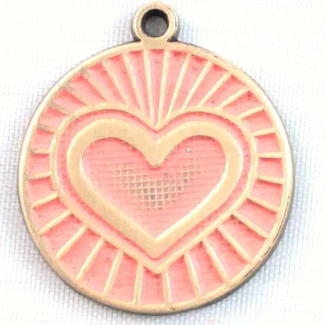 Antique bronze charm painted pink and burnished to shiny gold. One side depicts a beaming heart. Reverse side says "Blessed".