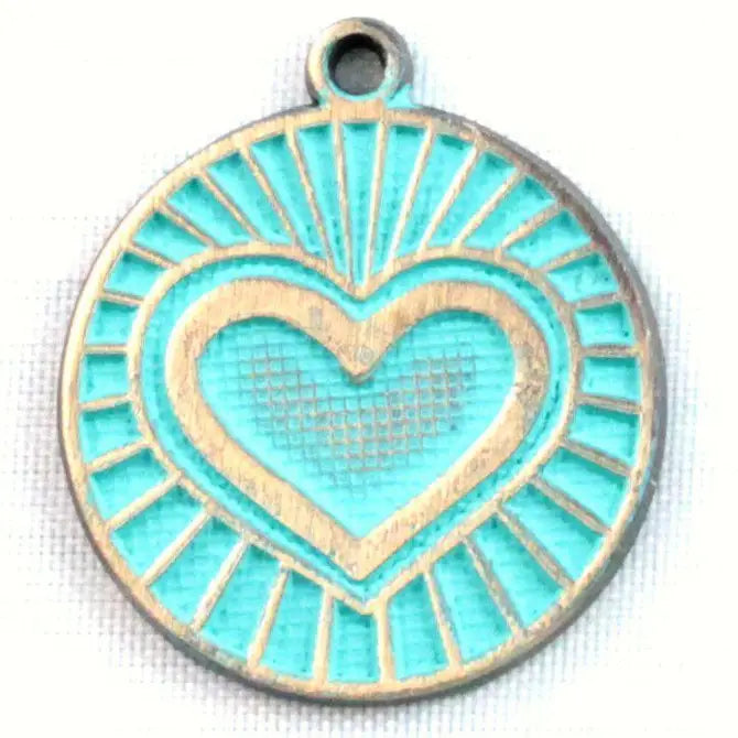 Antique bronze charm painted turquoise and burnished to shiny gold. One side depicts a beaming heart. Reverse side says "Blessed".