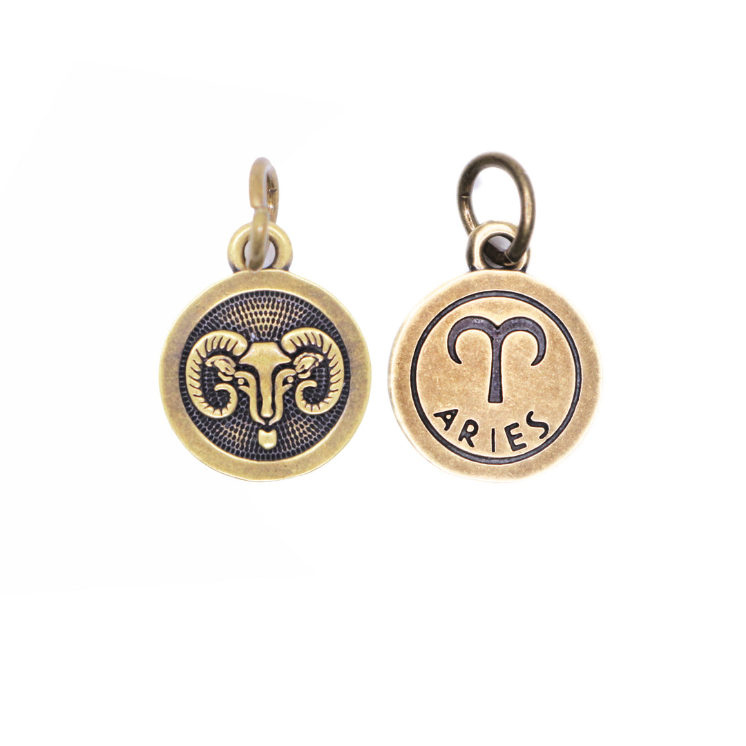 Brass-tone Aries zodiac charm painted black. One side is illustrated with a ram. Reverse side shows the ram side and says "ARIES".