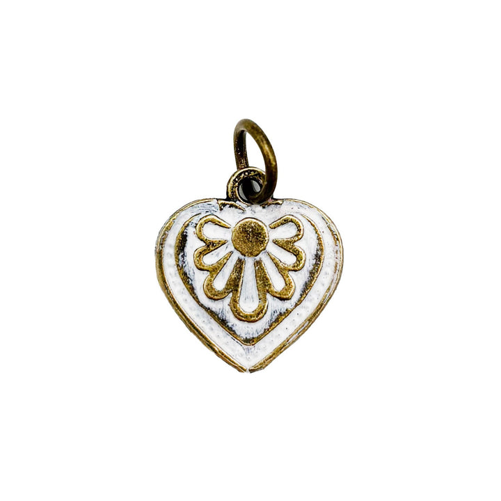 Antique bronze charm painted white and burnished to shiny gold. Graphic details mimic a blooming flower. Comes with attached jump ring.