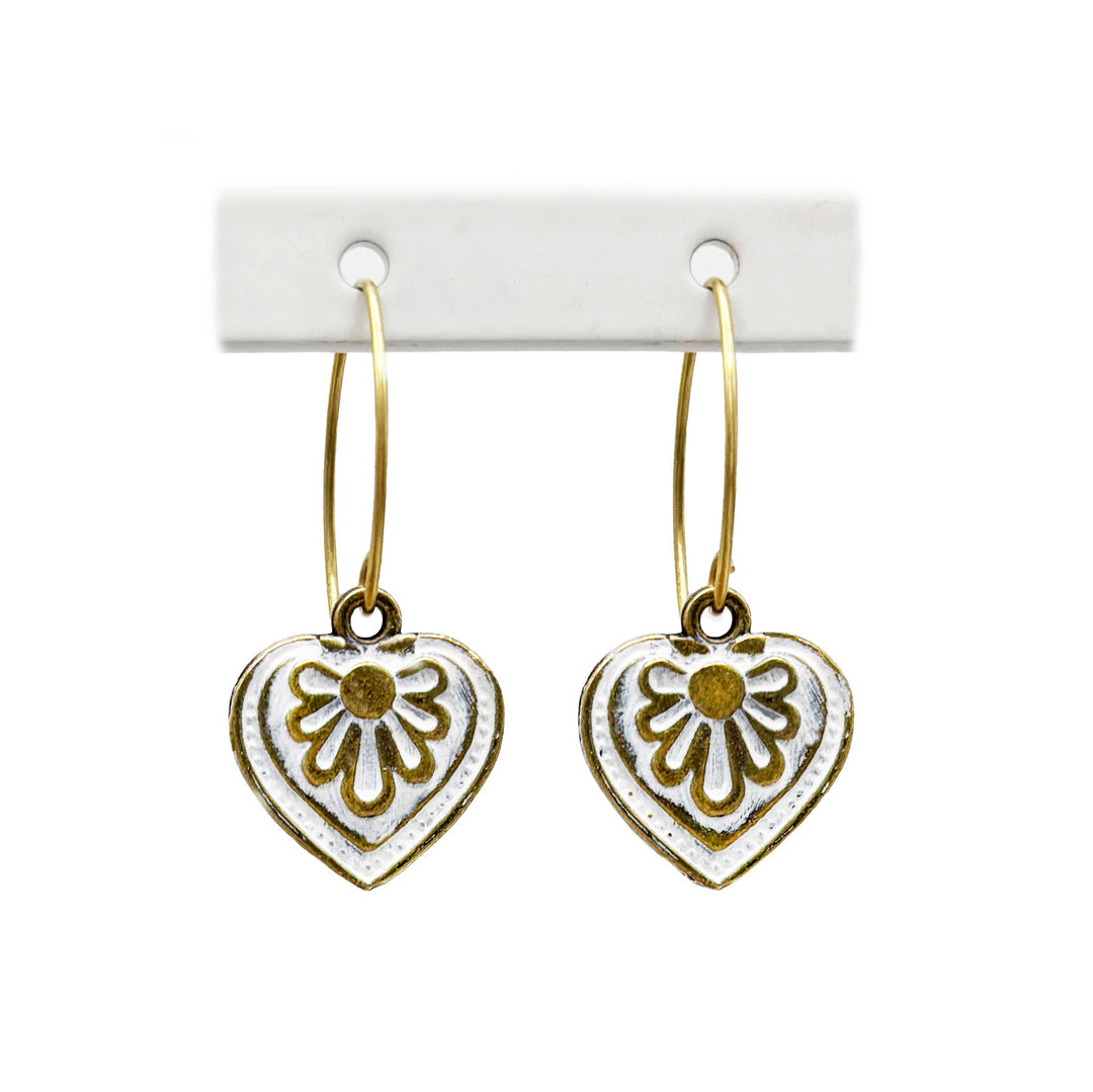 Antique bronze charms painted white and burnished to shiny gold. on 1" gold ear loops. Graphic details mimic a blooming flower.