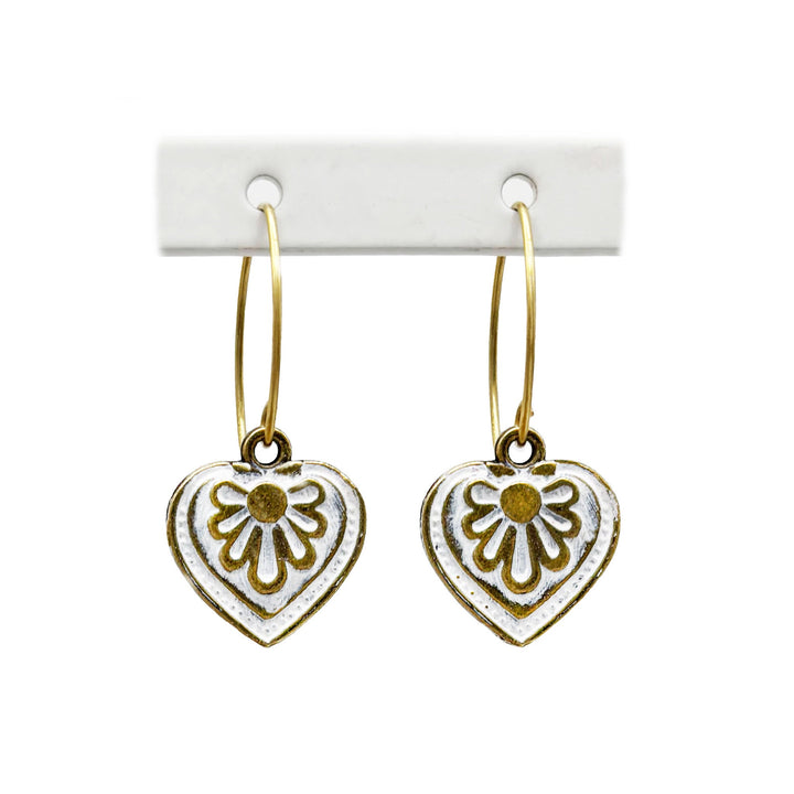 Antique bronze charms painted white and burnished to shiny gold. on 1" gold ear loops. Graphic details mimic a blooming flower.