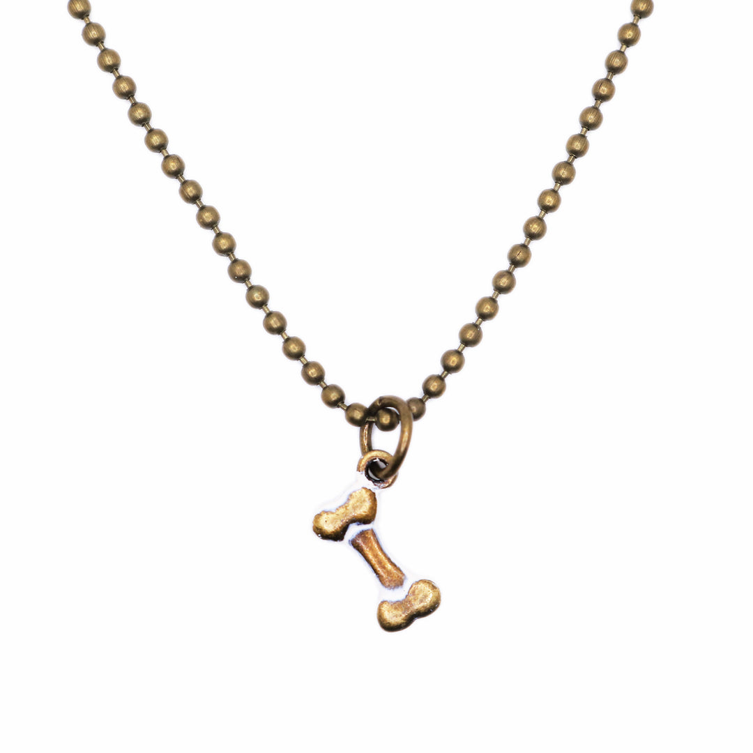 Antique bronze bone charm painted cream and burnished bright on jump ring. Shown on 18" bronze ball chain.