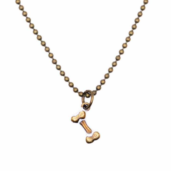 Antique bronze bone charm painted cream and burnished bright on jump ring. Shown on 18" bronze ball chain.