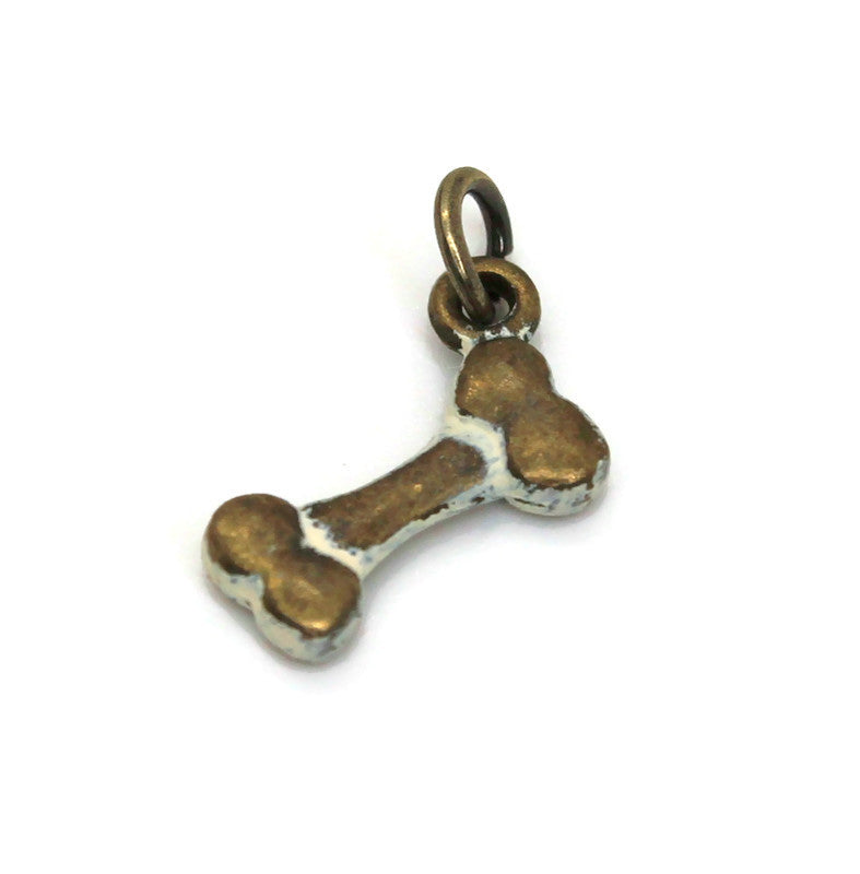 Antique bronze bone charm painted cream and burnished bright on jump ring.