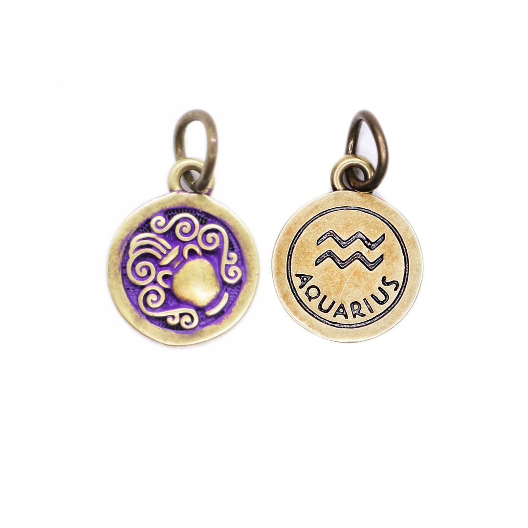 Brass-tone Aquarius zodiac charm painted purple. One side depicts an urn overflowing with water. Reverse side shows the water sign and says "AQUARIUS".