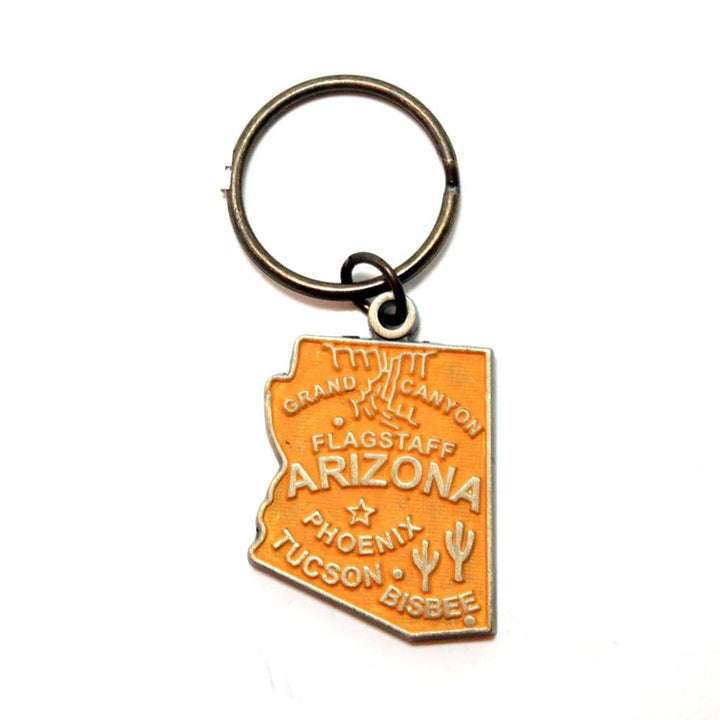 Antique bronze 1 5/8" charm keychain on 1 1/4" keyring. Alaska state charm painted orange and burnished to shiny gold. Map depicts location of Flagstaff, Phoenix, Tucson and Bisbee. Illustrated with the Grand Canyon and Saguaro cacti.