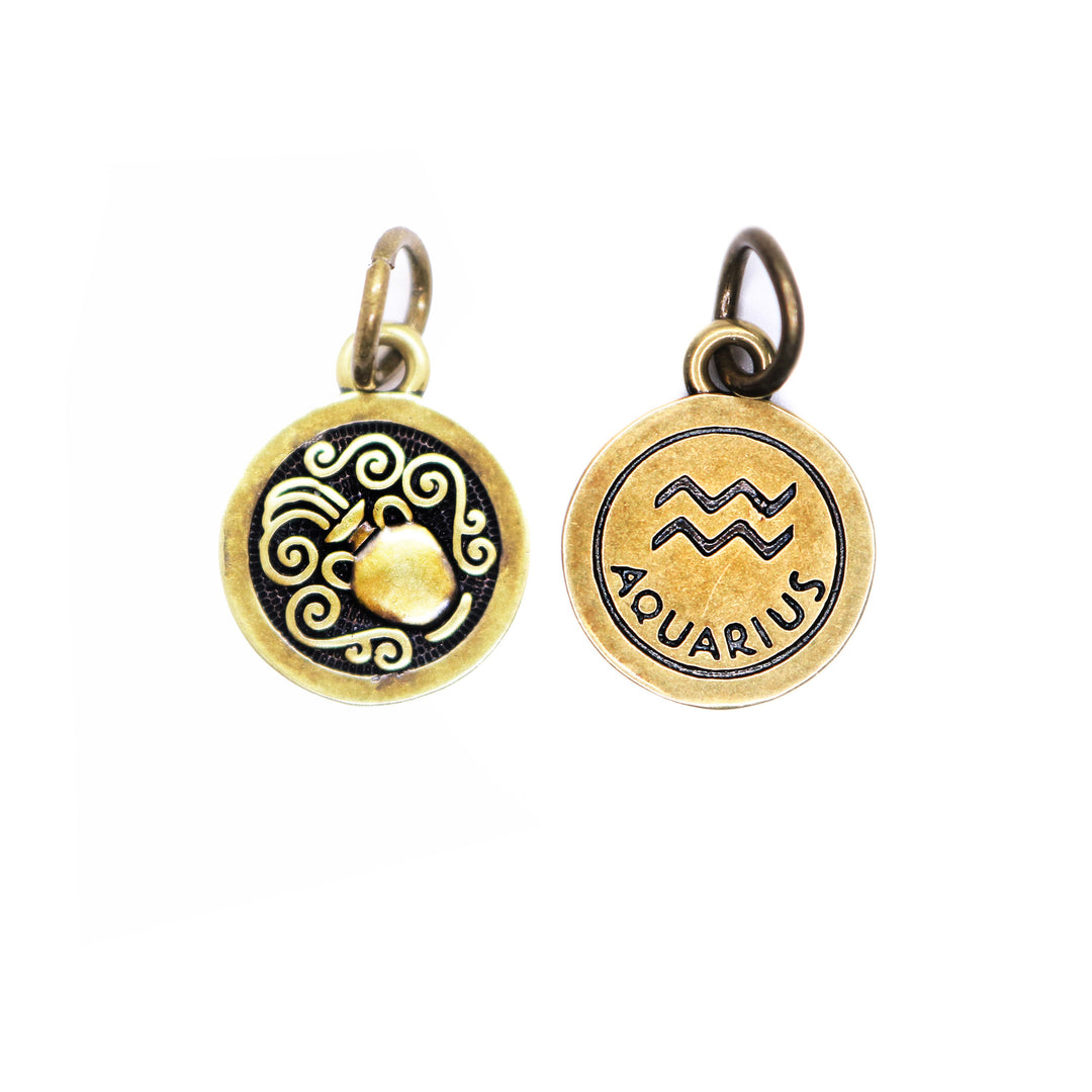 Brass-tone Aquarius zodiac charm painted black. One side depicts an urn overflowing with water. Reverse side shows the water sign and says "AQUARIUS".