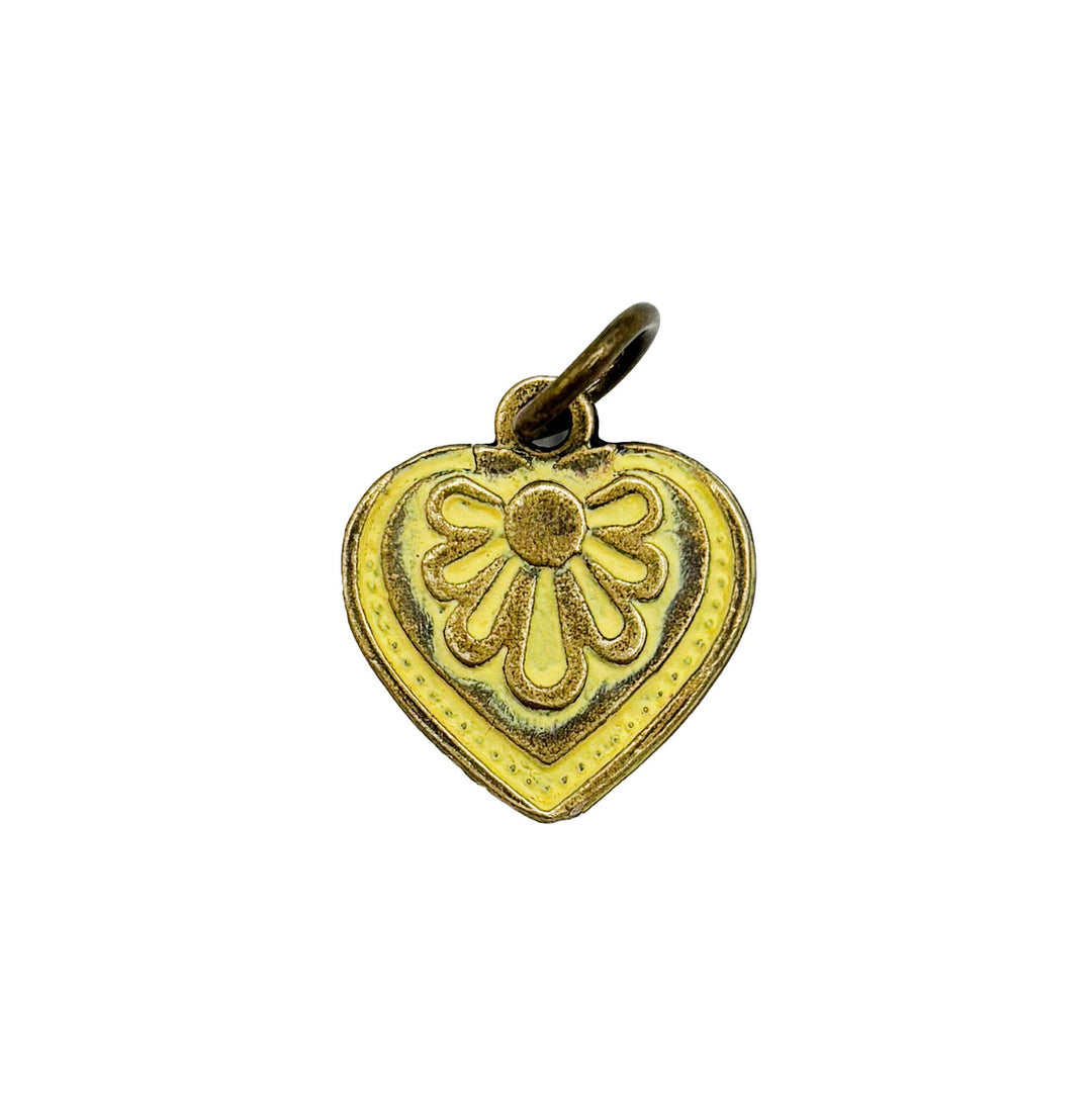 Antique bronze charm painted light yellow and burnished to shiny gold. Graphic details mimic a blooming flower. Comes with attached jump ring.